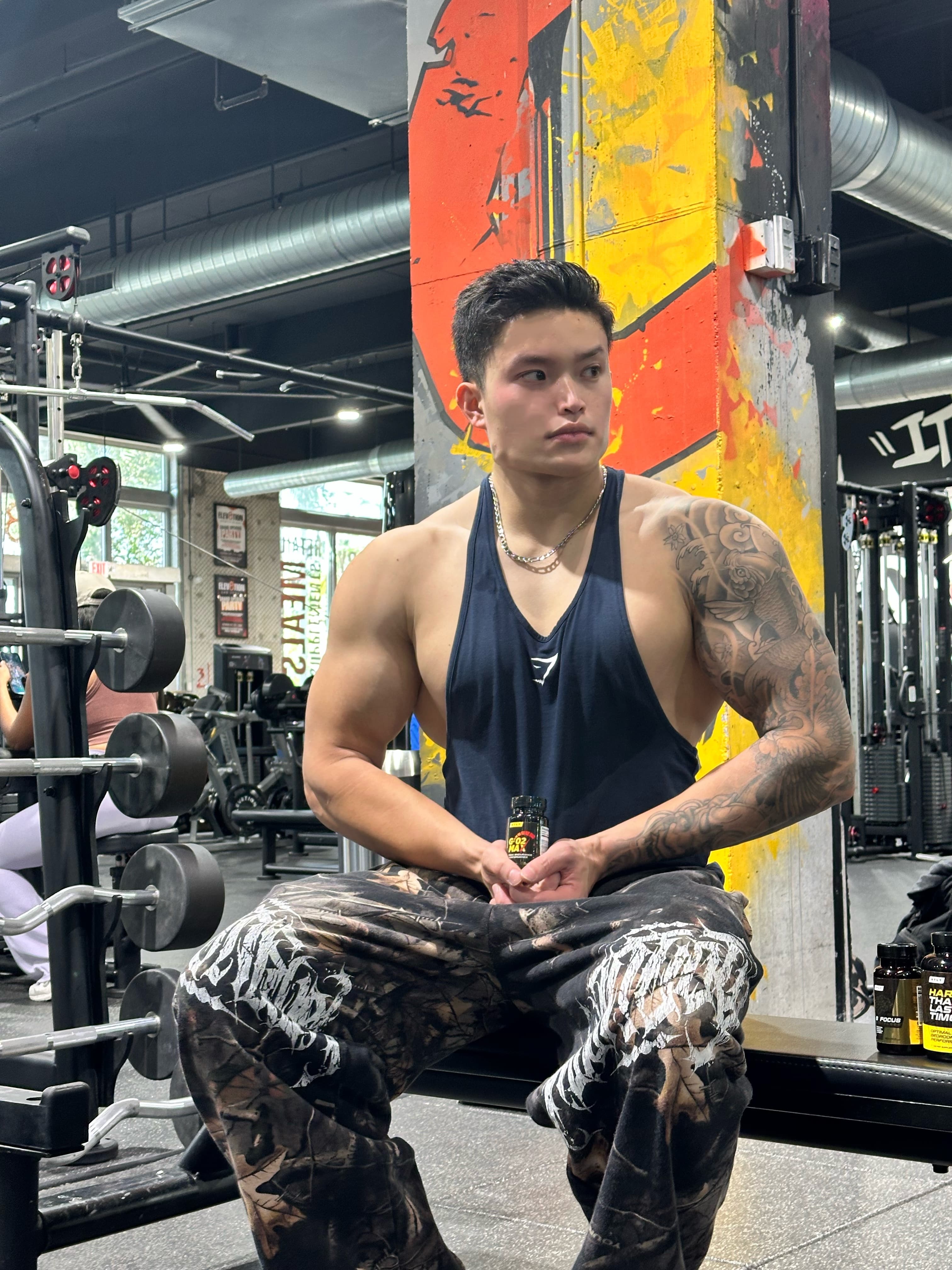 Clark at the gym holding HTLT supplements